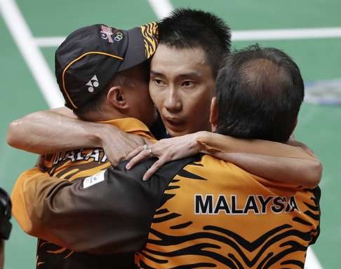 Malaysia's Lee Chong Wei celebrates with his coaches after advancing to the final. Photo: AP