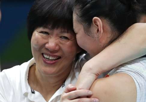 Lang Ping with Yan Ni after beating The Netherlands in the semi-finals. Photo: Reuters