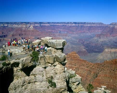 Tourists gather at a viewing platform on the South Rim.