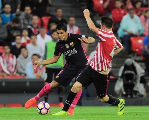 Luis Suarez vies with Athletic Bilbao’s Aymeric Laporte during the Spanish league match. Photo: AFP