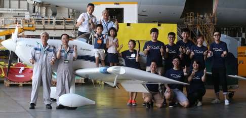 Pilot Hank Cheng Chor-hang (top, left), members of the Inspiration team and guests pose for a picture with the Hong Kong-made plane. Photo: Dickson Lee
