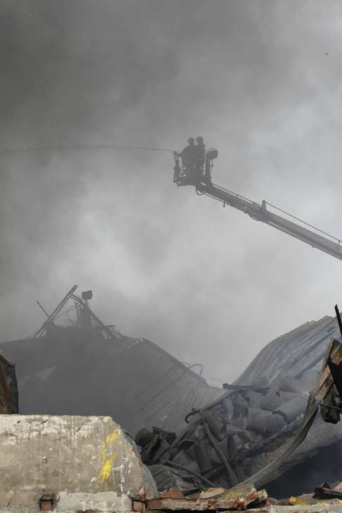 Firefighters work to put out the fire. Photo: AP