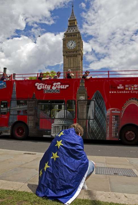 A demonstrator in central London, draped in an EU flag, protests against the outcome of Britian’s June 23 referendum on the European Union. Photo: AFP
