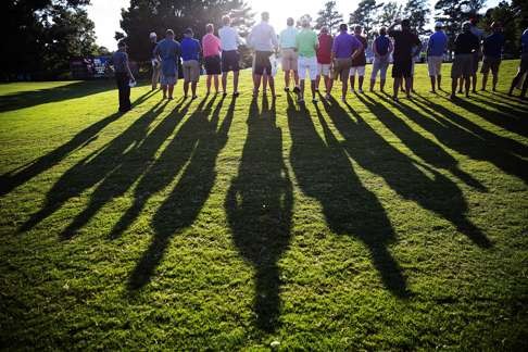 Spectators watch as Johnson putts on the 17th hole. Photo: AP