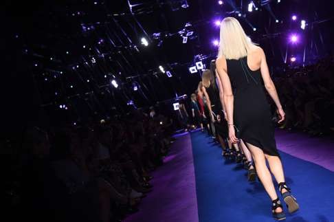 Versace models walk the Milan runway in flat-form sandals.Photo: AFP