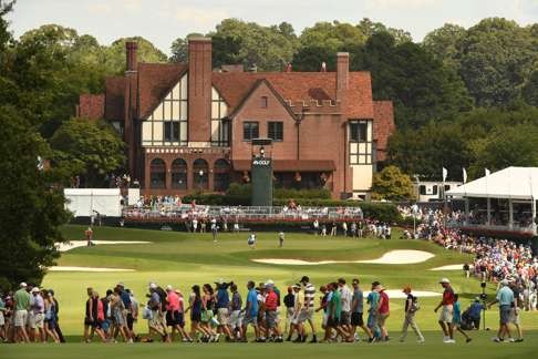 The clubhouse from the eighteenth fairway as Paul Casey and Ryan Moore play on the green during the third round of the Tour Championship. Photo: USA Today