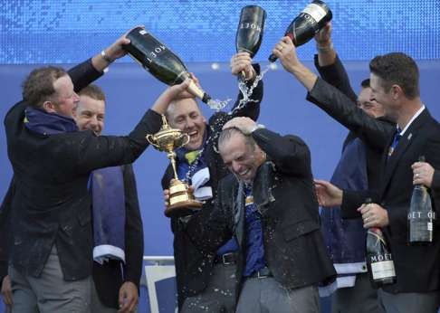 Europe’s players pour champagne over captain Paul McGinley as they celebrate winning the 2014 Ryder Cup at Gleneagles. Photo: AP