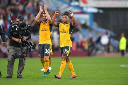 Arsenal’s Alex Oxlade-Chamberlain (C) and Shkodran Mustafi celebrate after the win over Burnley that lifts Arsenal into third spot in the EPL. Photo: AP
