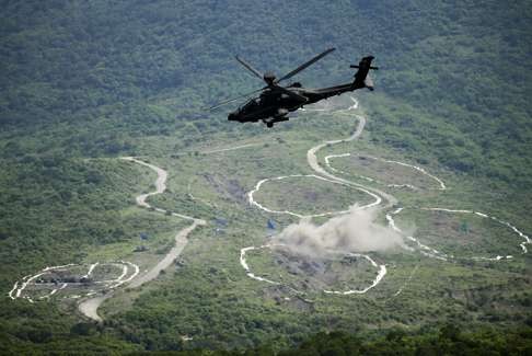 A Taiwan army Apache attack helicopter fires a missile during an annual military exercise in Pingtung county in August. Photo: EPA