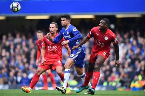 Diego Costa with Leicester City’s Wes Morgan and Danny Drinkwater. Photo: AFP
