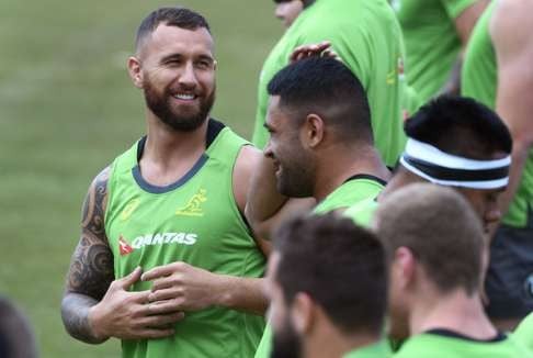 Wallabies player Quade Cooper (L) speaks with teammates during a training session in Sydney. Photo: AFP
