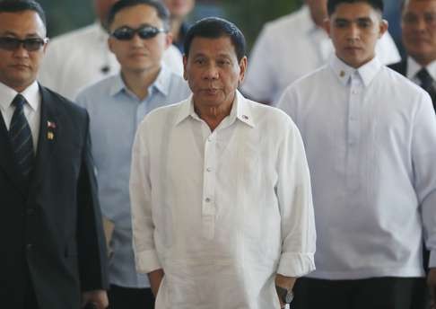 Philippine President Rodrigo Duterte is escorted prior to boarding his flight for a three-day official visit to Japan. Photo: AP