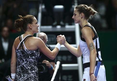 Agnieszka Radwanska (left) shakes hands with Karolina Pliskova after winning the match. Photo: EPA