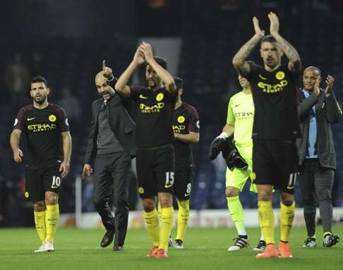 Manchester City manager Pep Guardiola and players applaud their fans after their 4-0 win over West Brom. Photo: AP