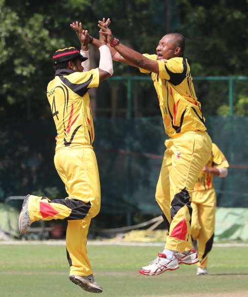 Tony Pala Ura (left) and Assad Vala celebrate a wicket against Hong Kong. Photo: Edward Wong