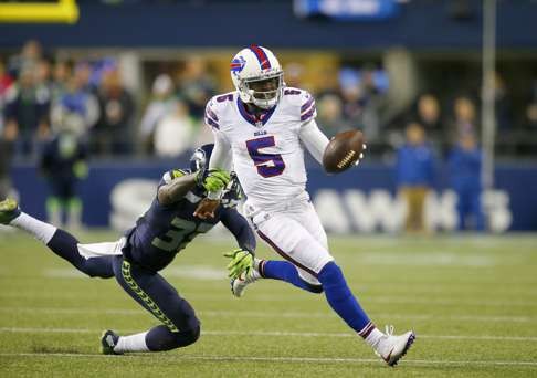 Quarterback Tyrod Taylor of the Bills is chased down by safety Kelcie McCray . Photo: AFP