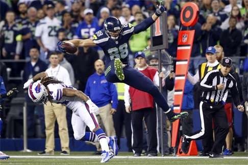 Seahawks tight end Jimmy Graham runs after the catch by hurdling a tackle from Buffalo cornerback Stephon Gilmore. Photo: USA Today