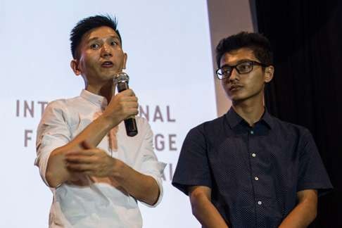 Midi Z (l) stands next to an interpreter as he speaks after the screening of The Road to Mandalay in Yangon. Photo: AFP