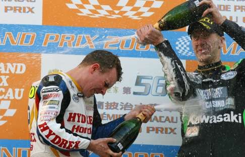 Stuart Easton and Hutchinson celebrate with champagne after the 2009 Macau Motorcycle Grand Prix. Photo: Sam Tsang