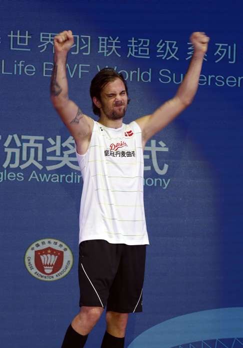 Jan O Jorgensen stands on the podium after winning the China Open. Photo: AP