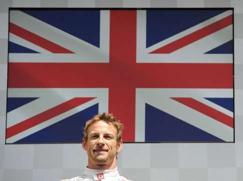 Jenson Button in front of the British flag after winning the 2012 Belgium Grand Prix. Photo: AFP