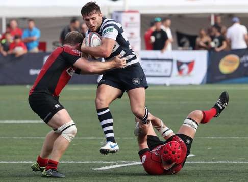 HKFC’s Tom Isaacs is caught by his Valley opponents. Photo: Edward Wong