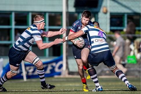 Hong Kong Scottish fly half Gregor McNeish tests his HKFC opponent. Photo: SCMP Pictures