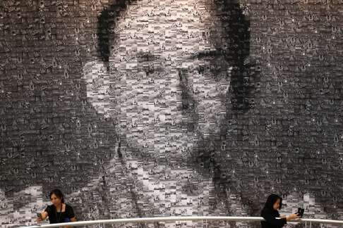 Two women take selfies in front of a collage, at an exhibition held to honour the late King Bhumibol Adulyadej at the Bangkok Art and Culture Centre. Following the death of the single most steadfast US ally in Southeast Asia since the second world war, the US “pivot” to Asia – and Thailand’s pivotal role in it – has likewise passed. Photo: Reuters