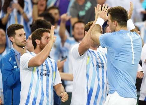 Argentina players celebrate Del Potro’s win. Photo: AFP