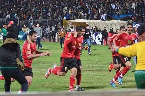 Players try to flee the Port Said Stadium as violence escalates.