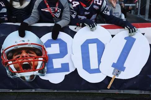 Fans holds signs in support of Brady. Photo: AFP
