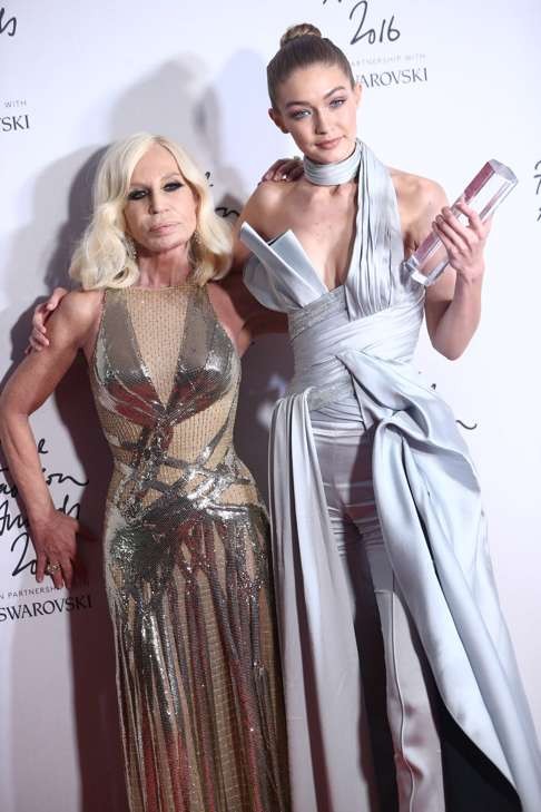 Gigi Hadid, winner of the international model award, and designer Donatella Versace pose at The Fashion Awards in London. Photo: Reuters