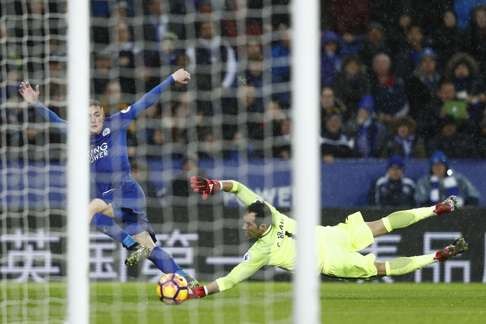 Vardy takes the ball around Manchester City goalkeeper Claudio Bravo on his way to scoring his third goal. Photo: AFP