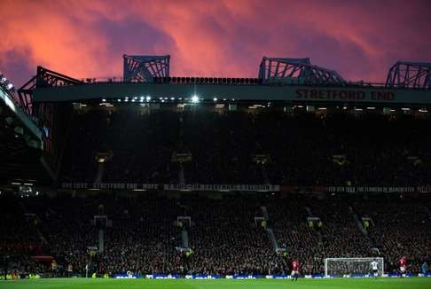 Old Trafford cuts a glorious sight as the sun goes down over Manchester. Photo: EPA