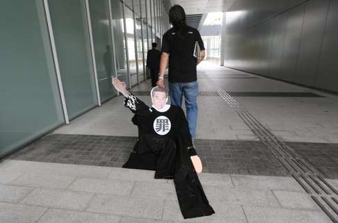 In May 2013: Legislator Leung Kwok-hung drags along an effigy of Chief Executive Leung Chun-ying at the Legislative Council building. Photo: Sam Tsang