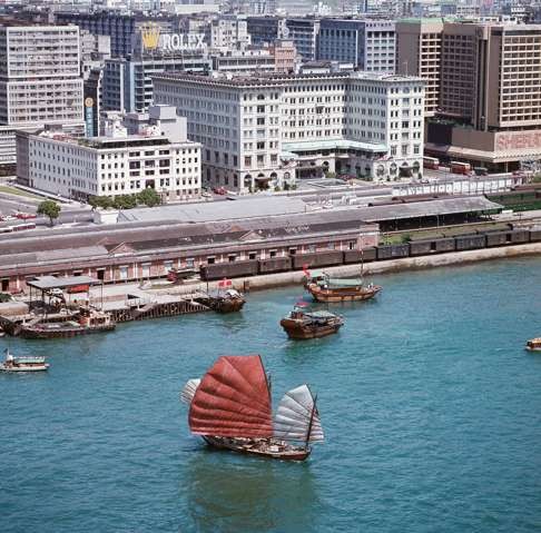 The Peninsula Hotel and the YMCA in Tsim Sha Tsui, with a junk boat, taken from a helicopter in 1976. Photo: Keith Macgregor