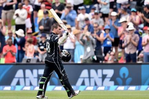 New Zealand's Tom Latham lifts his bat to the crowd as he walks from the field. Photo: AFP