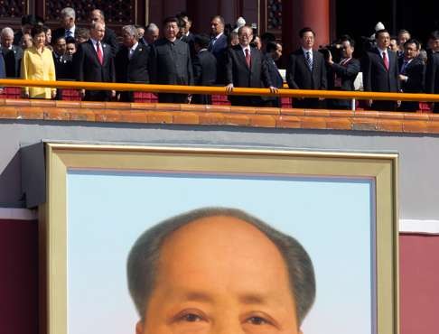 Chinese President Xi Jinping with other world leaders stands on top of Tiananmen Gate, above the portrait of Mao Zedong, to watch a military parade in 2015. Xi’s grasp on power has elevated him to the ranks of Mao Zedong and Deng Xiaoping. Photo: AFP