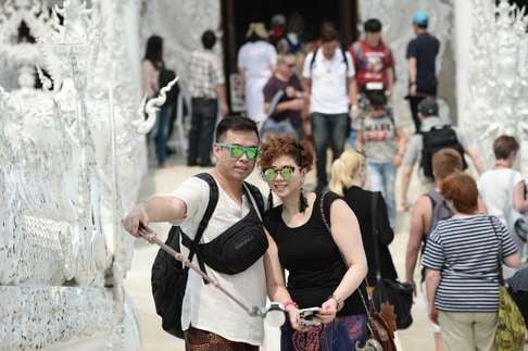 Chinese tourists take a selfie at the White Temple in Chiang Rai, northern Thailand. Photo: AFP