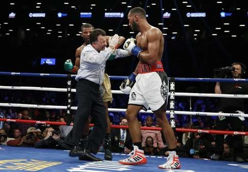 Jack accidentally lands a blow on fight referee Arthur Mercante Jnr after the bell. Photo: Reuters