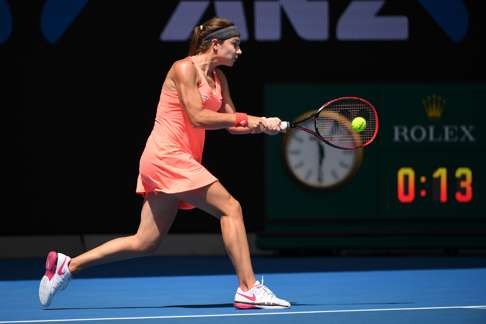 Switzerland's Stefanie Voegele hits a return against Venus Williams. Photo: AFP