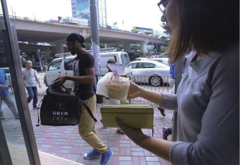 Post reporter Rachel Cheung receives her delivery from UberEats. Photo: May Tse