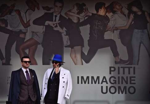 Visitors attend the opening day of the Pitti Uomo show in Florence. Photo: EPA