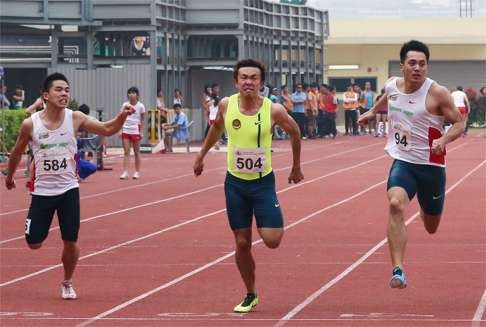 Runners in action in the men's 100m final at the 2015 Hong Kong Athletics Series 2 at Wan Chai Sports Ground.