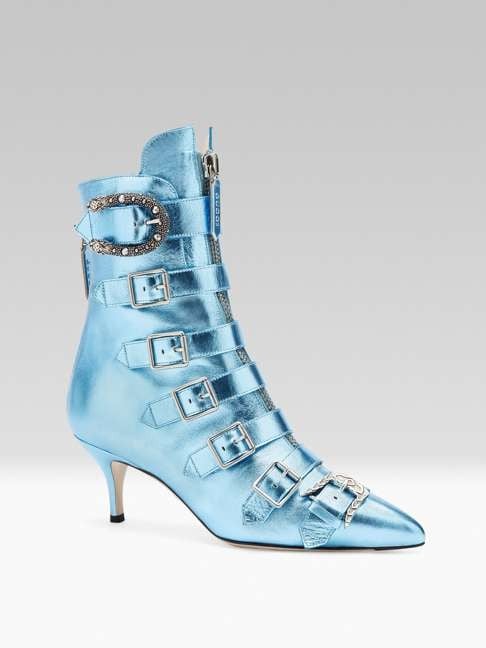 Gucci. The front zipper, the studded tiger head buckle and the Baroque-shaped buckle are the icing on this pair of metallic blue mid-heel ankle boots. Price on request