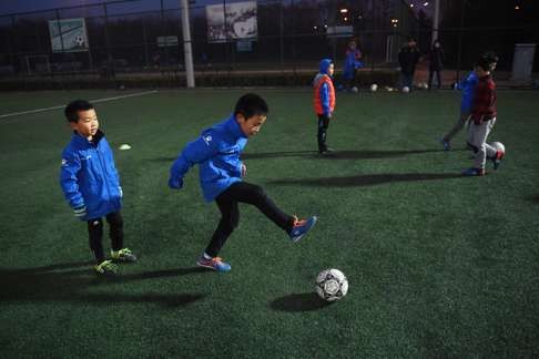 Youngsters practising at a football club in Beijing. Photo: AFP