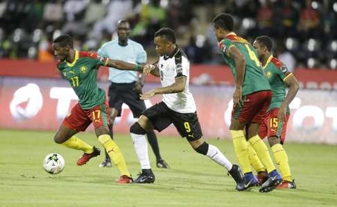 Ghana’s Jordan Ayaw challenges Cameroon’s Sutchuin Djoum Gilles Arnaud. Photo: AP