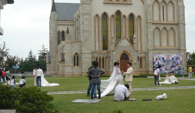 Thames Town’s cathedral – a direct copy of the Christ Church in Bristol – draws so many Chinese couples posing for wedding portraits that a prop table adorned with a fake wedding cake, bottle of champagne, and basket of baguettes remains standing in front of it at all times. Photo credit: Bianca Bosker