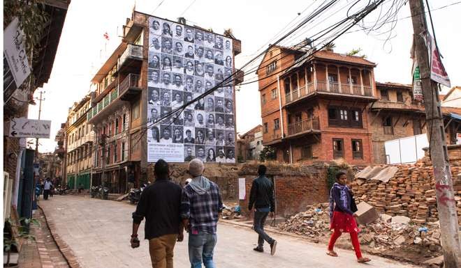 The cracks in the old houses from the April earthquake were temporarily hidden behind photos. Photo: Shikhar Bhattarai.