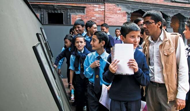 Students browse photos in Patan. Photo: Pawan Joshi.